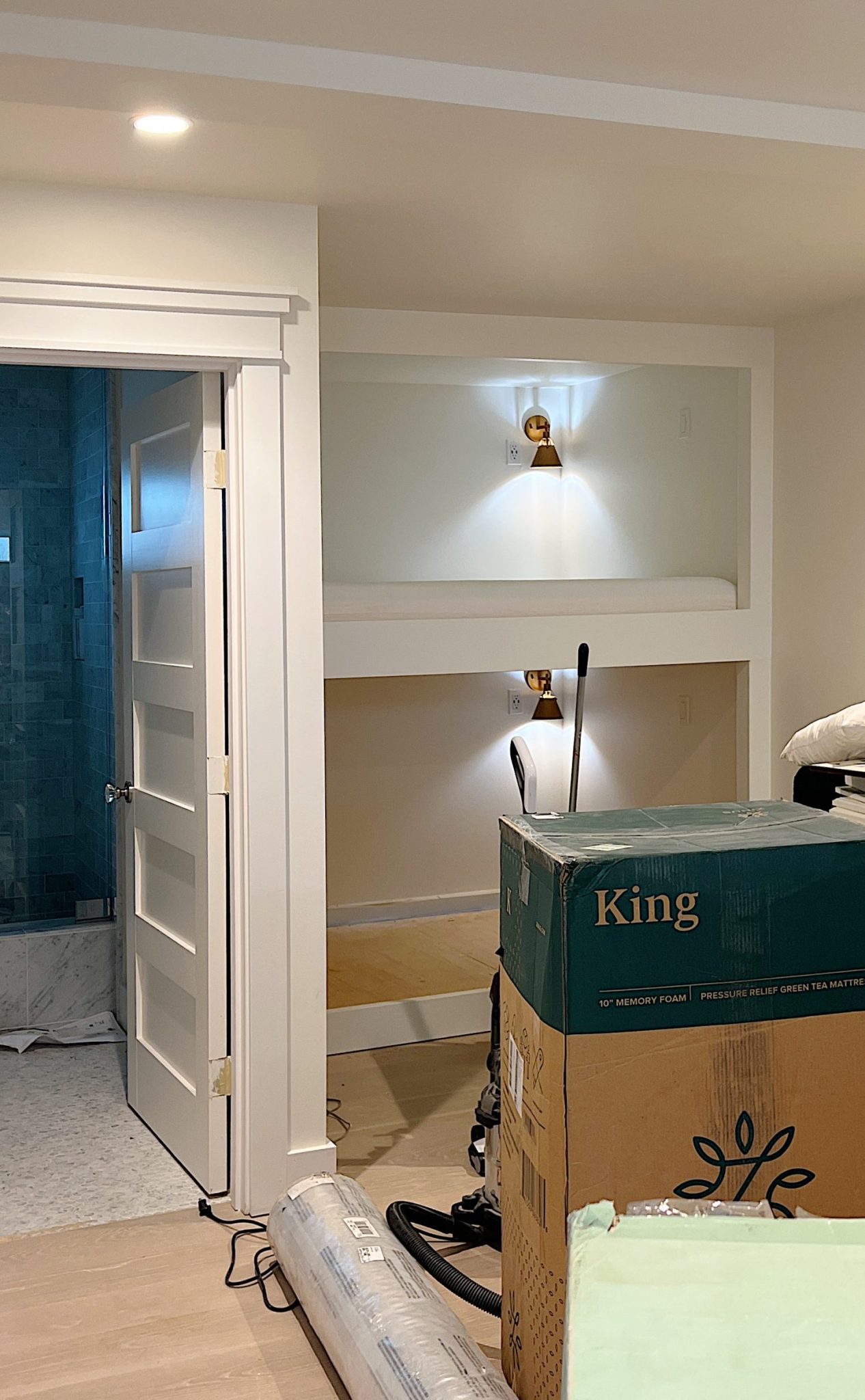 Bedroom with Zinus mattress in a box, a rug, and bunk beds in the background.
