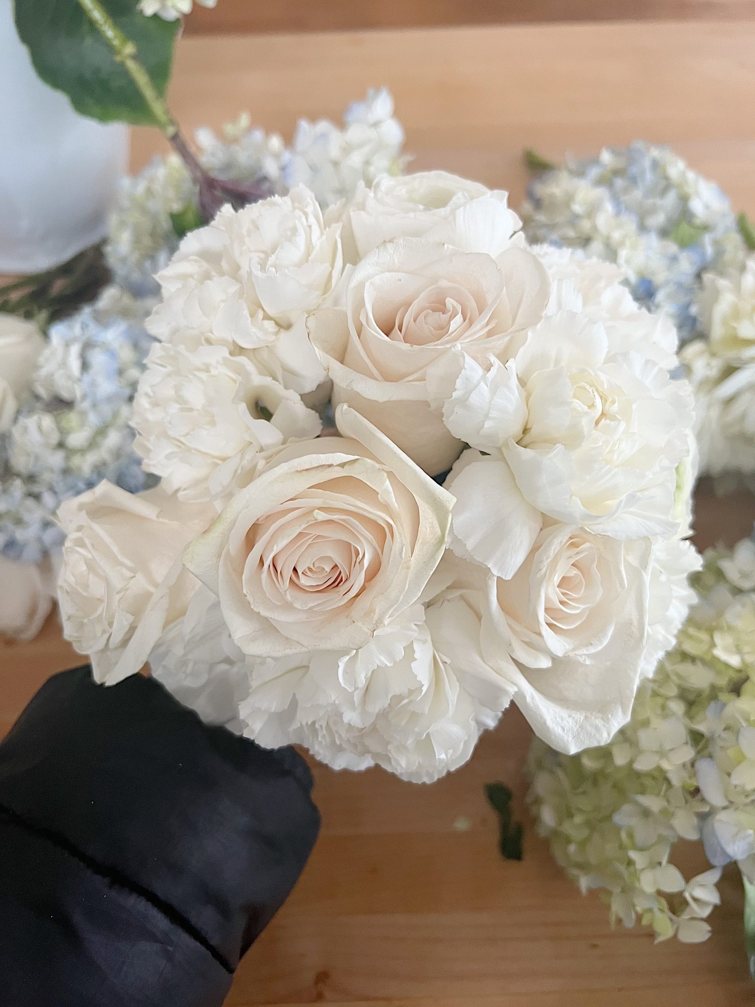 a bouquet of white lfowers and hydrangeas.
