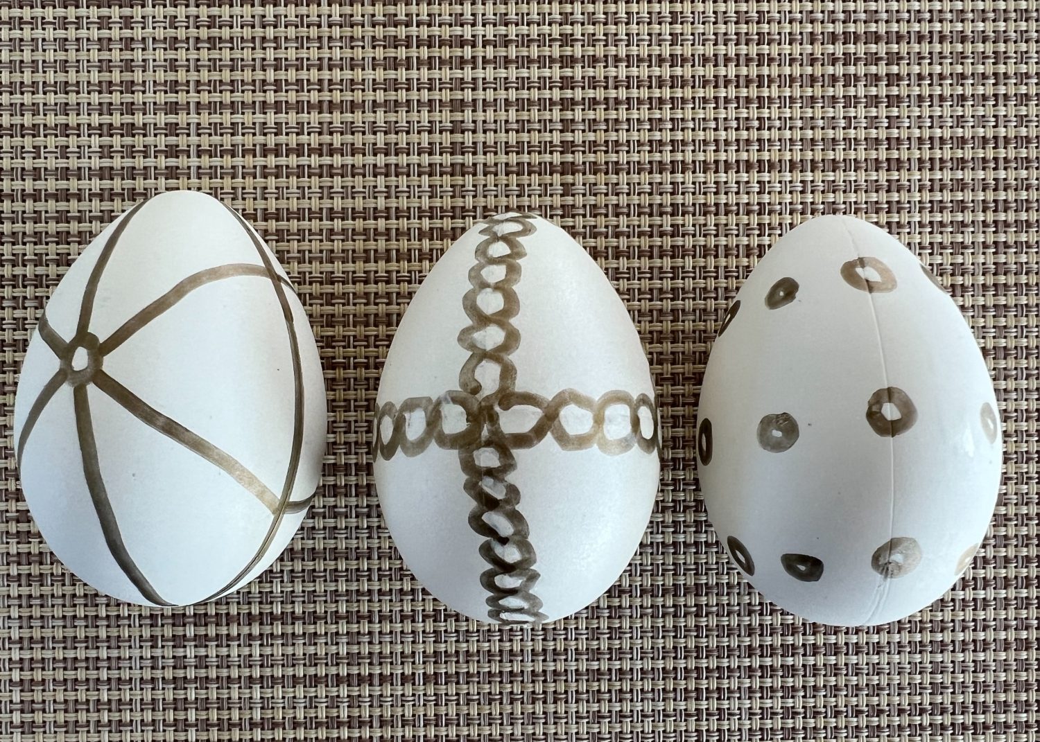 White plastic Easter eggs painted with a copper sharpie pen