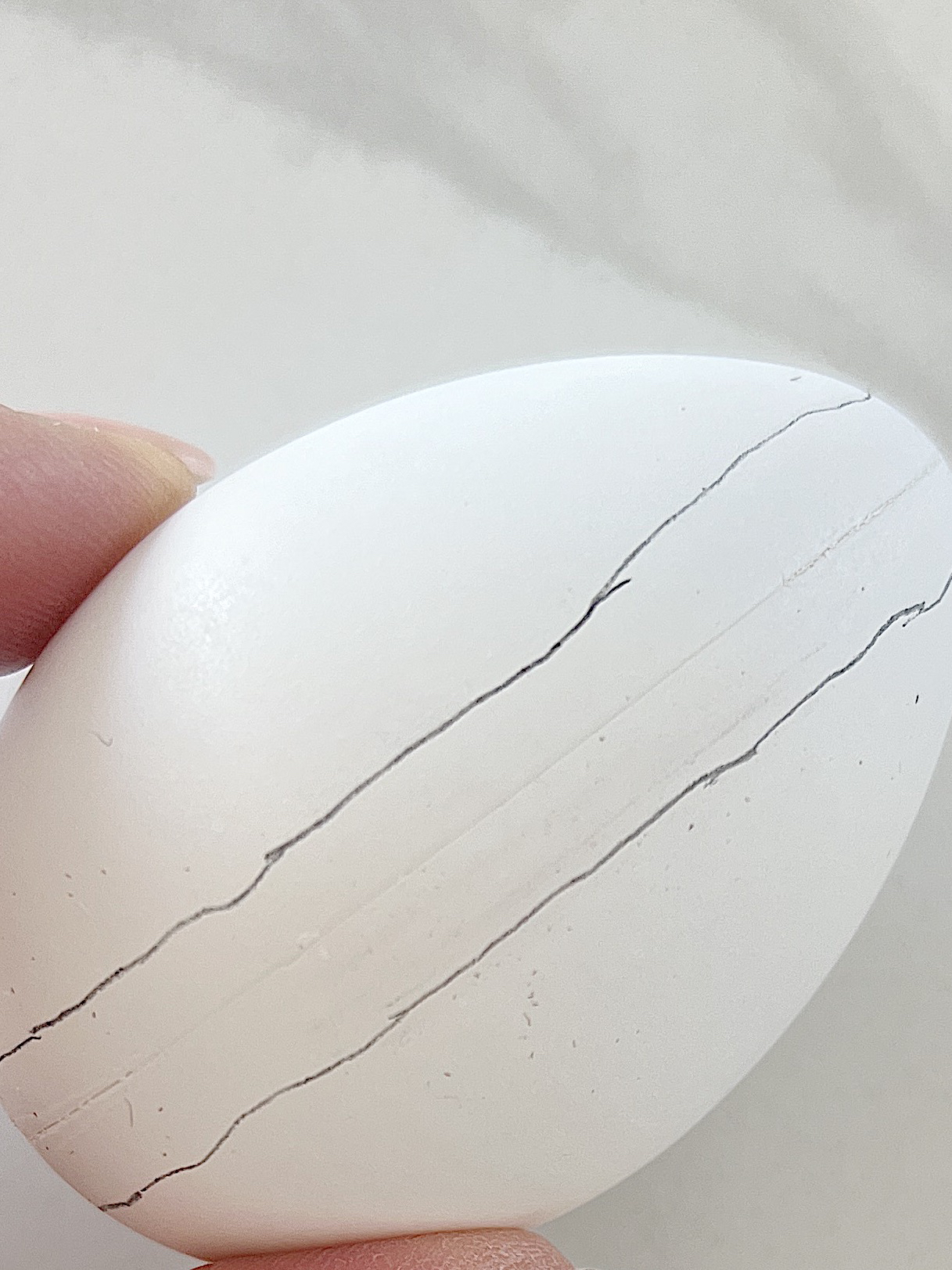 White plastic Easter eggs painted with a copper sharpie pen