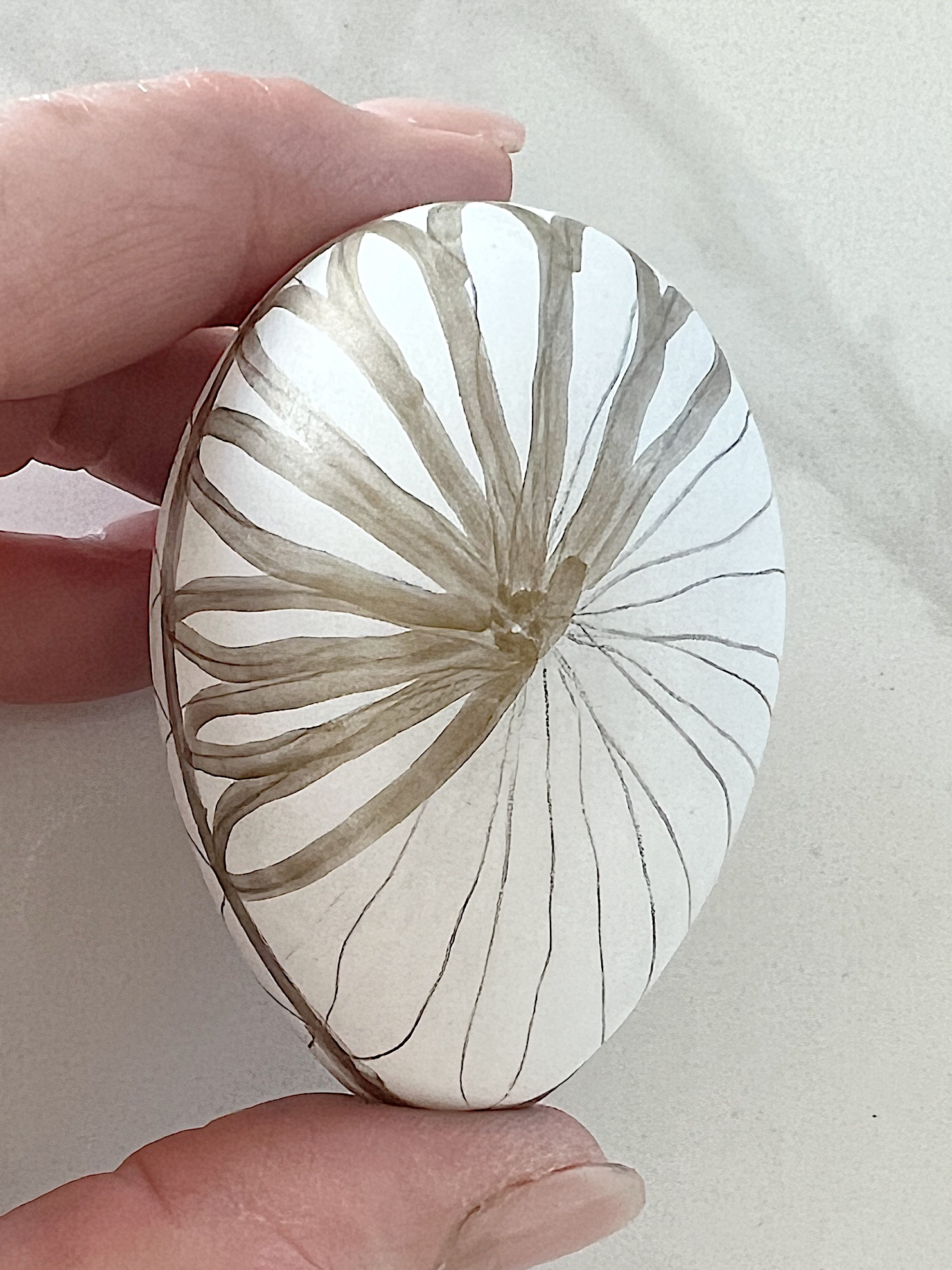 White plastic Easter eggs painted with a copper sharpie pen