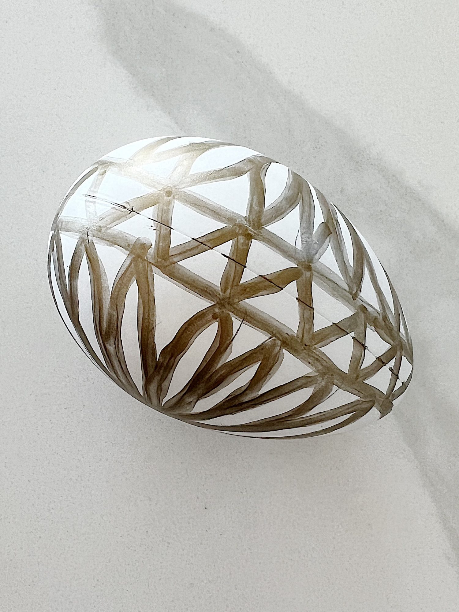 White plastic Easter eggs painted with a copper sharpie pen