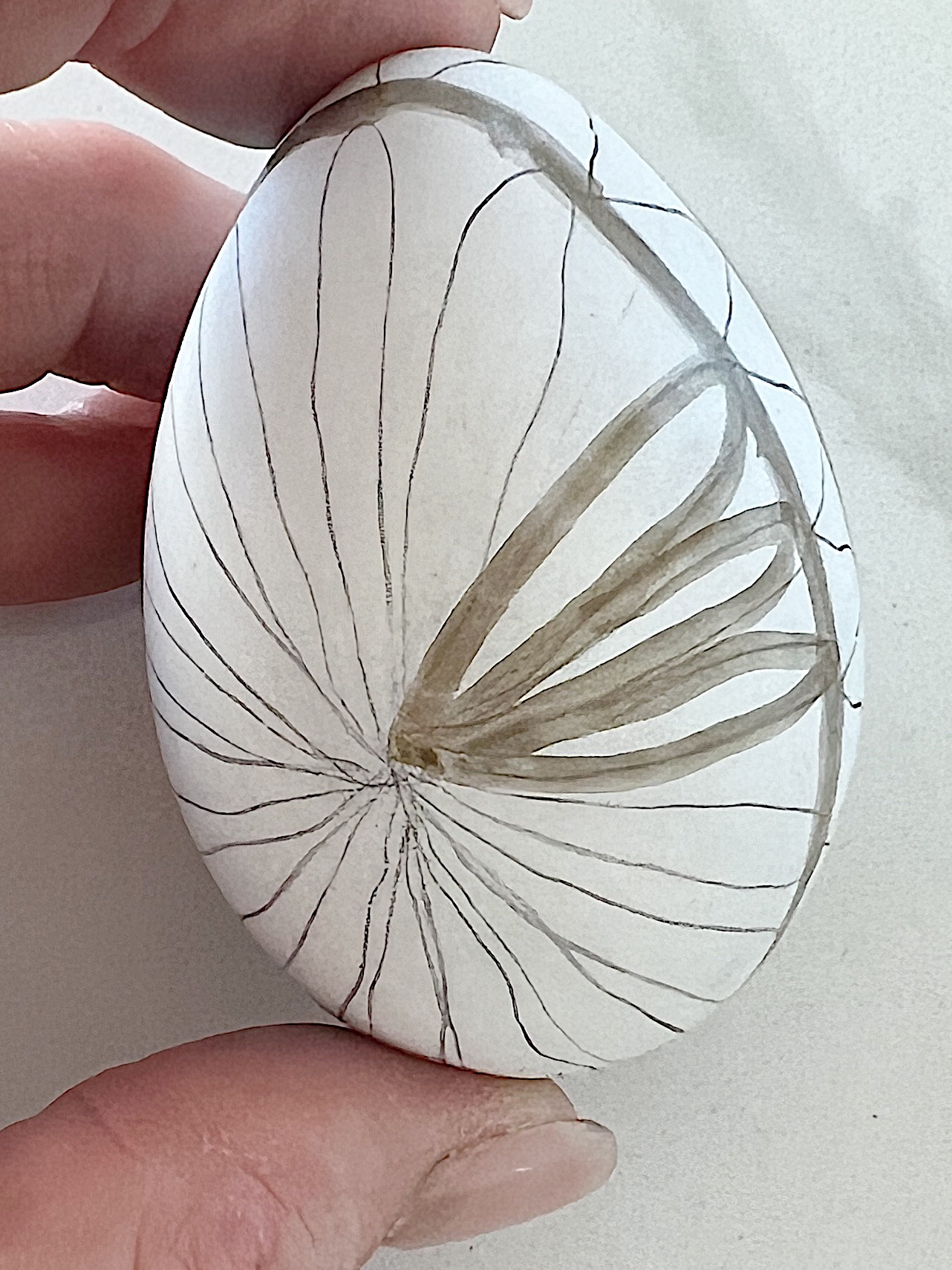 White plastic Easter eggs painted with a copper sharpie pen