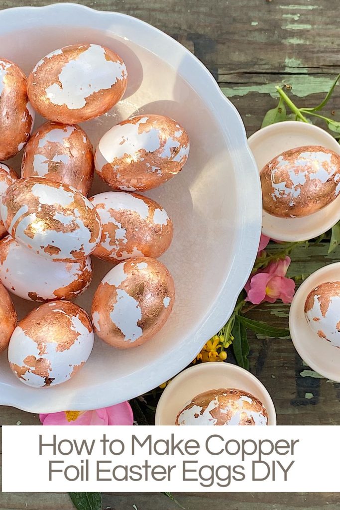 plastic white eggs covered with copper foil in a white bowl.