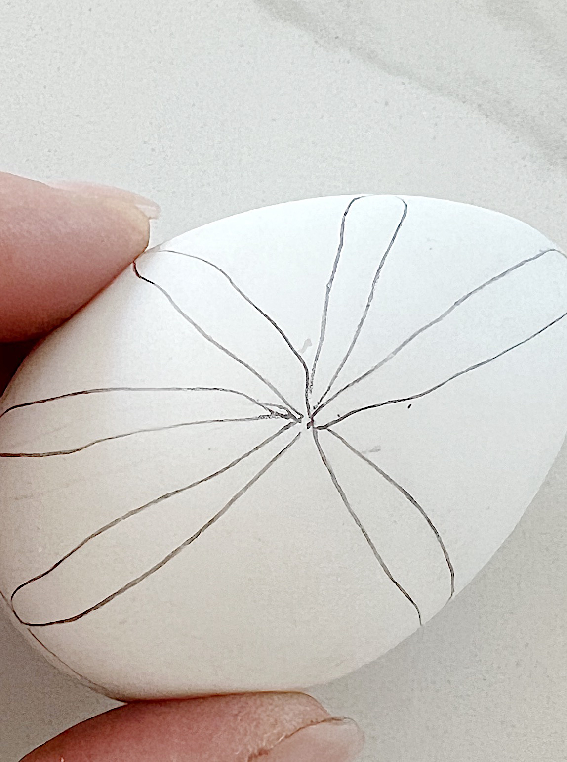 White plastic Easter eggs painted with a copper sharpie pen