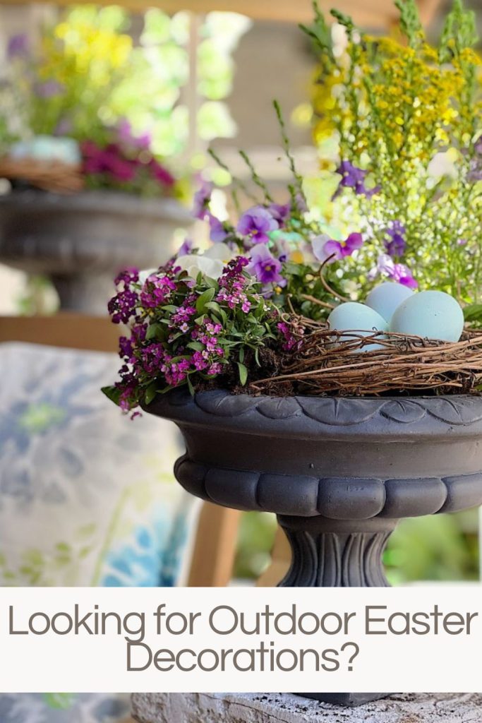 Outdoor planter filled with purple and white flowers with a nest and light blue easter eggs.