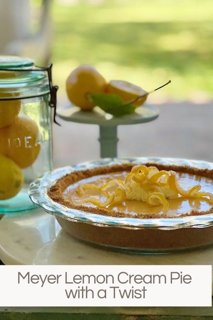 A Meyer Lemon Crema pie with a small cake plate and vintage jar filed with meyer lemons.