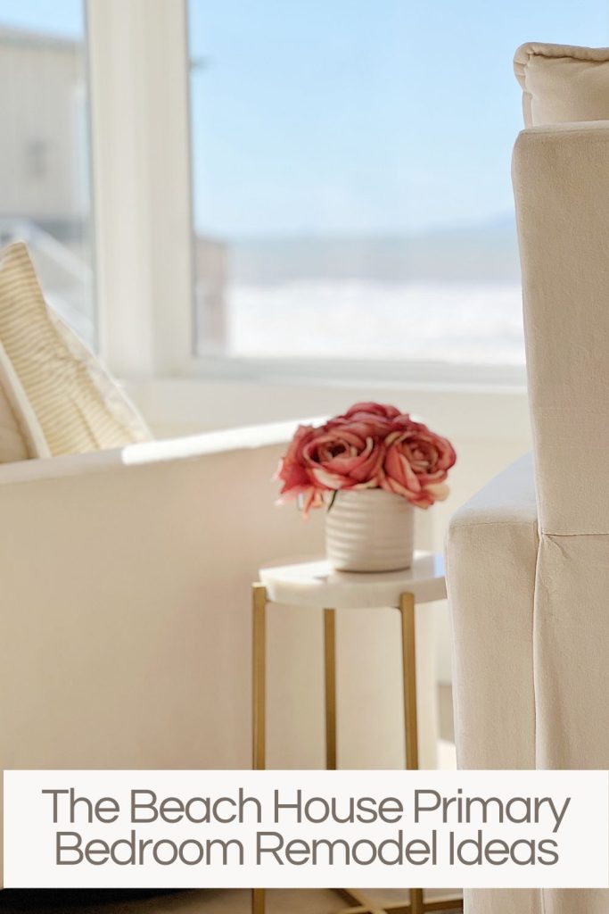 two white swivel chairs with small table in between with pot and pink-orange roses