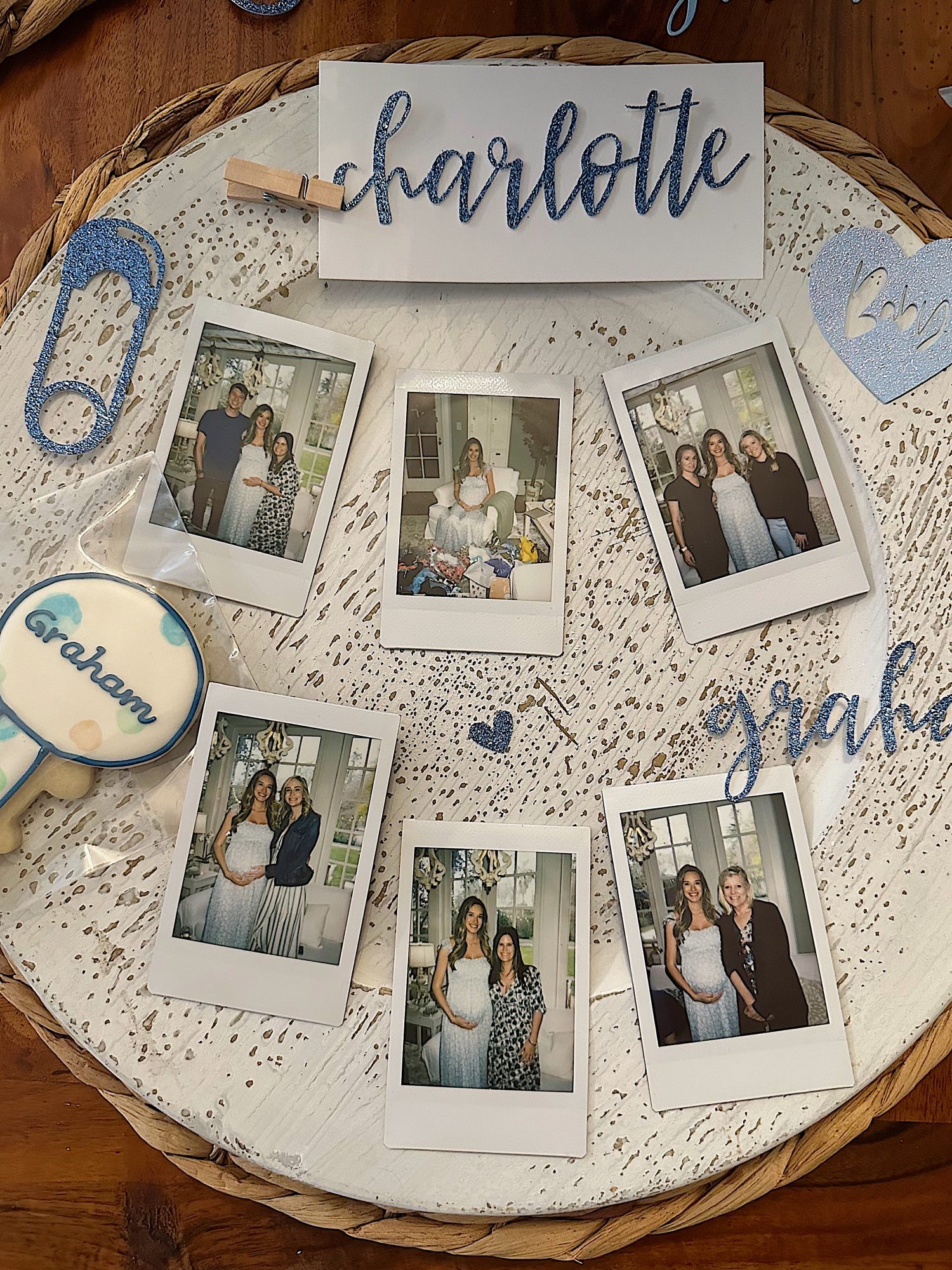 place cards, polaroid photos, word cut outs, and a baby rattle cookie with the name Graham.