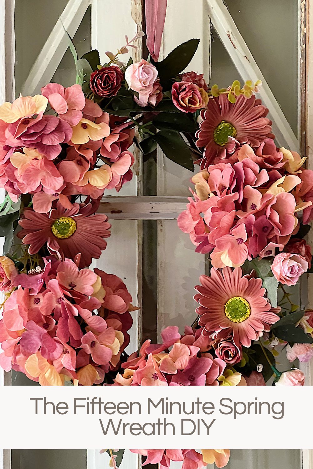 Making a spring wreath with a grapevine base and faux flowers is a fun and easy DIY project. Plus you can make this in fifteen minutes!