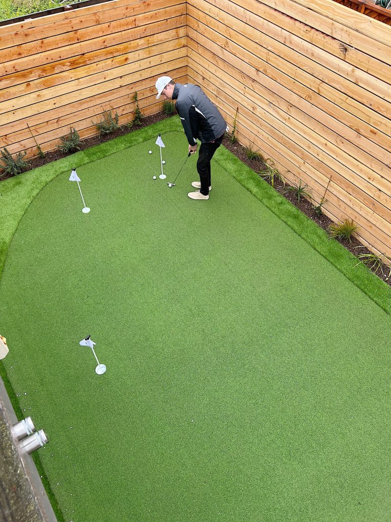 a small putting green in the back yard