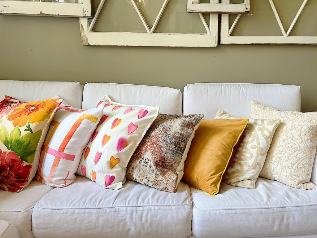 Colorful spring throw pillows on a couch.