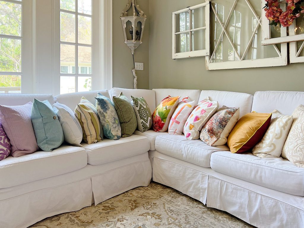 Colorful spring throw pillows on a couch.