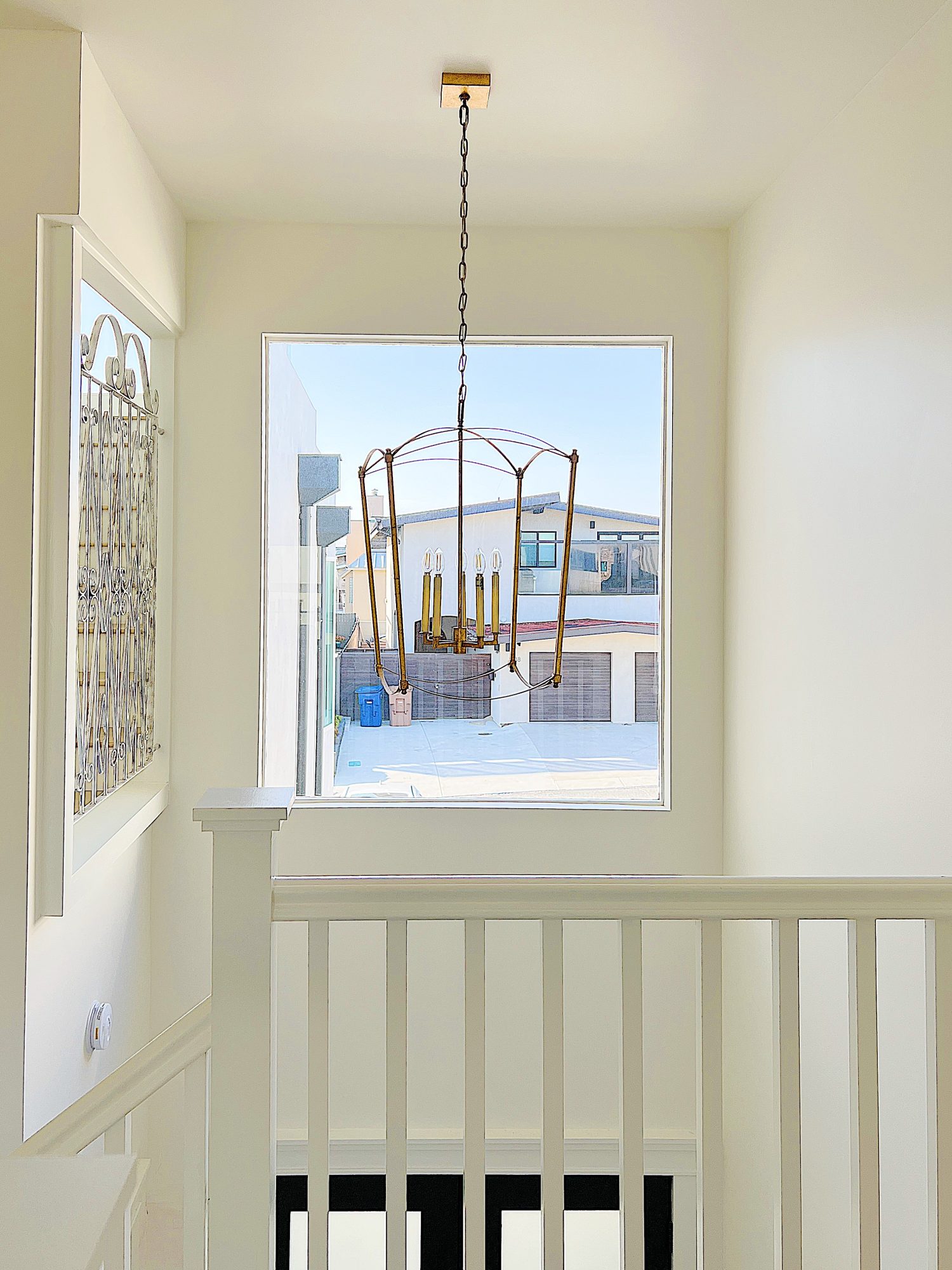 A gold chandelier in the entryway of our beach house.