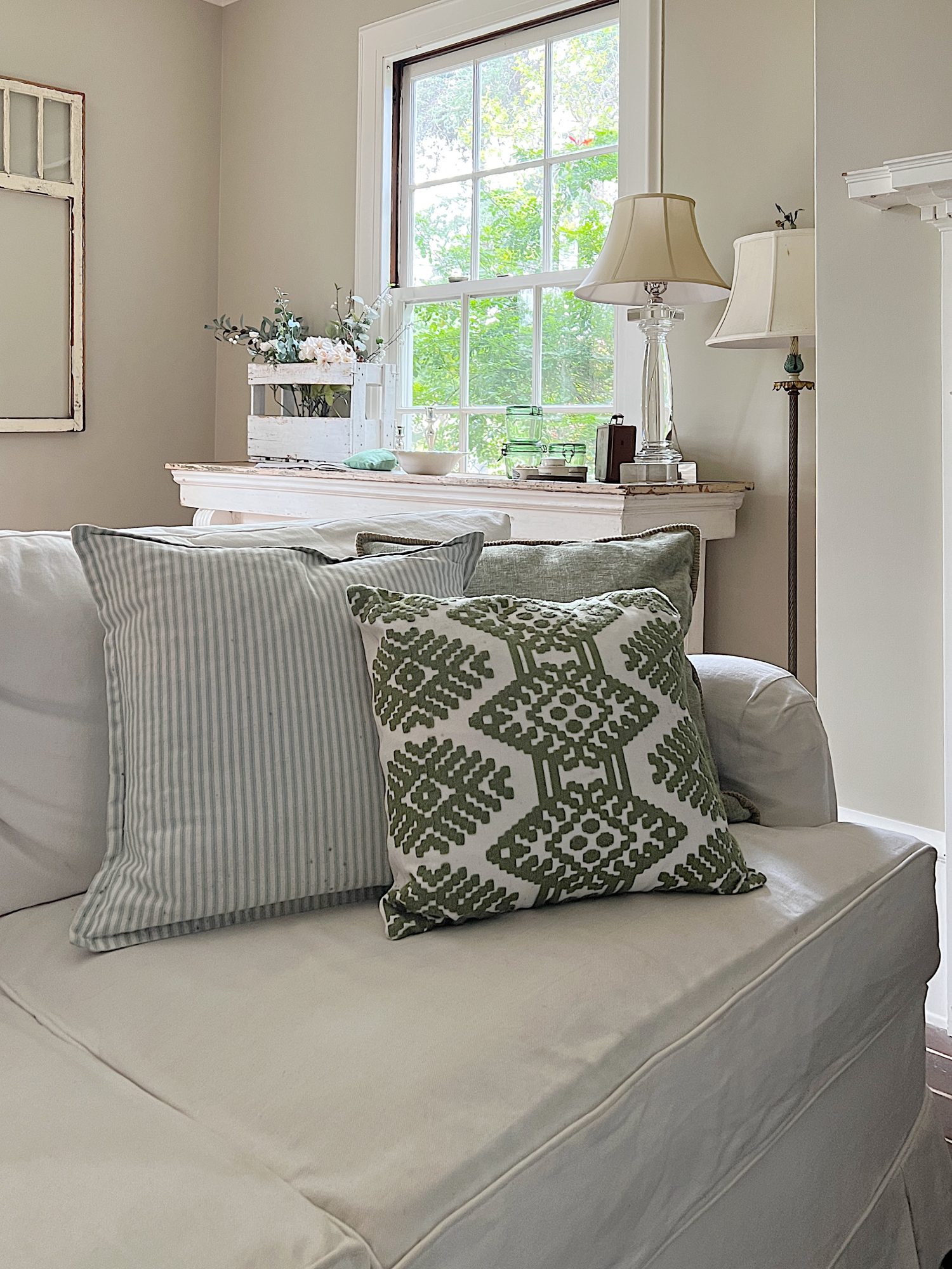 Green throw pillows on a white couch.