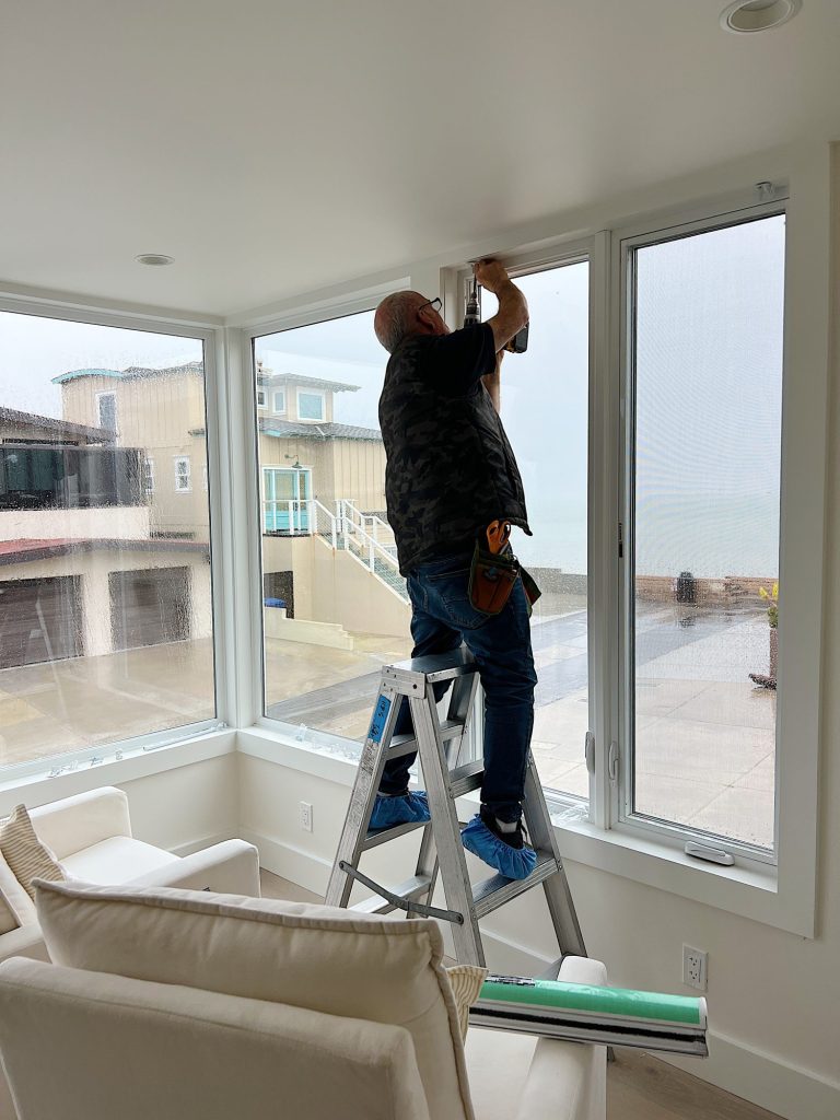 Installation of the blinds in our primary bedroom in our beach house with five windows and an ocean view.