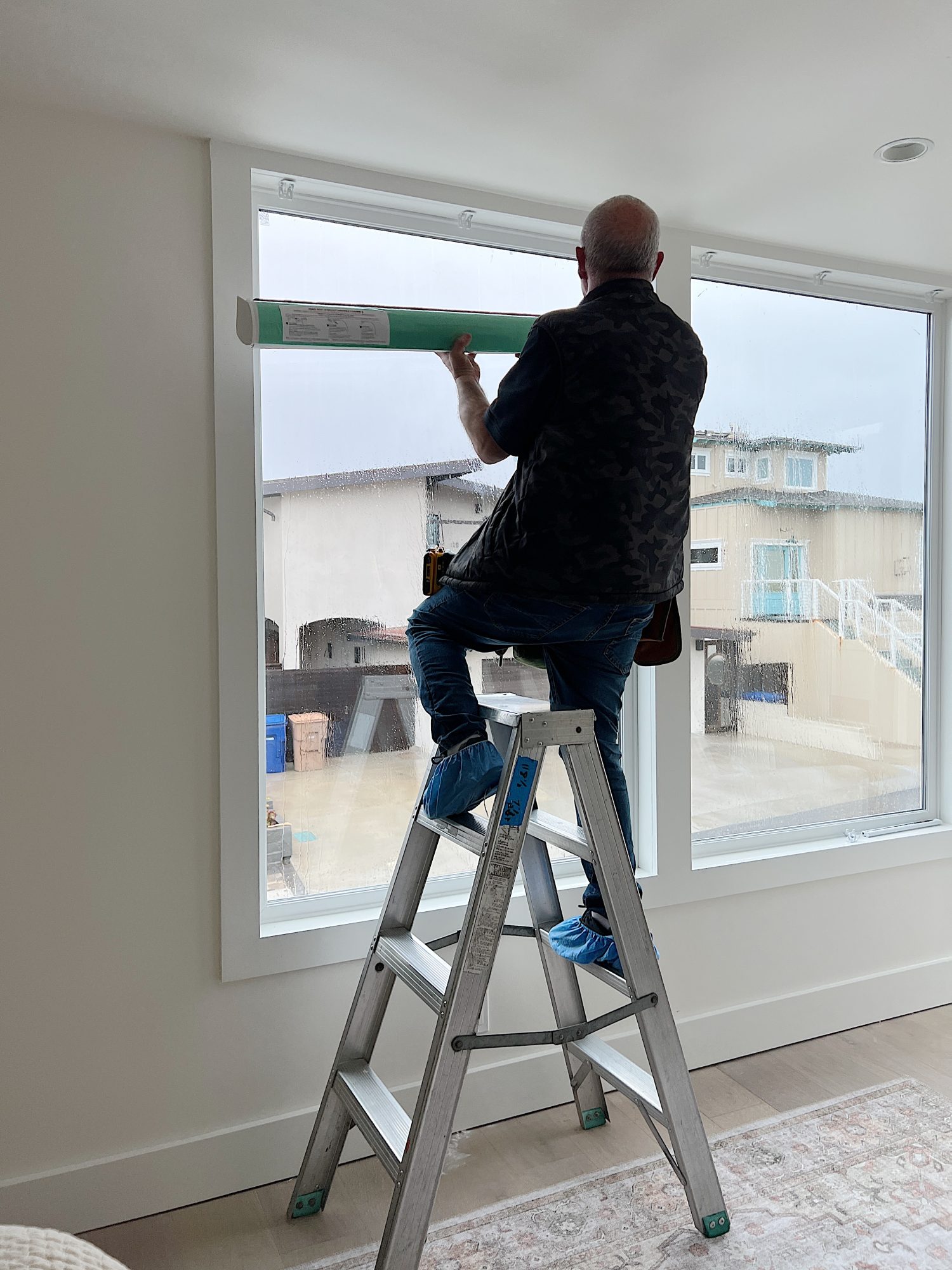 Installation of the blinds in our primary bedroom in our beach house with five windows and an ocean view.