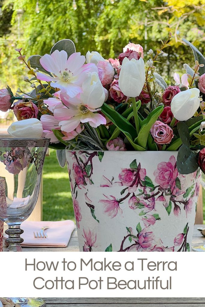 A pot of pink and white flowers covered with a floral patterned napkin.