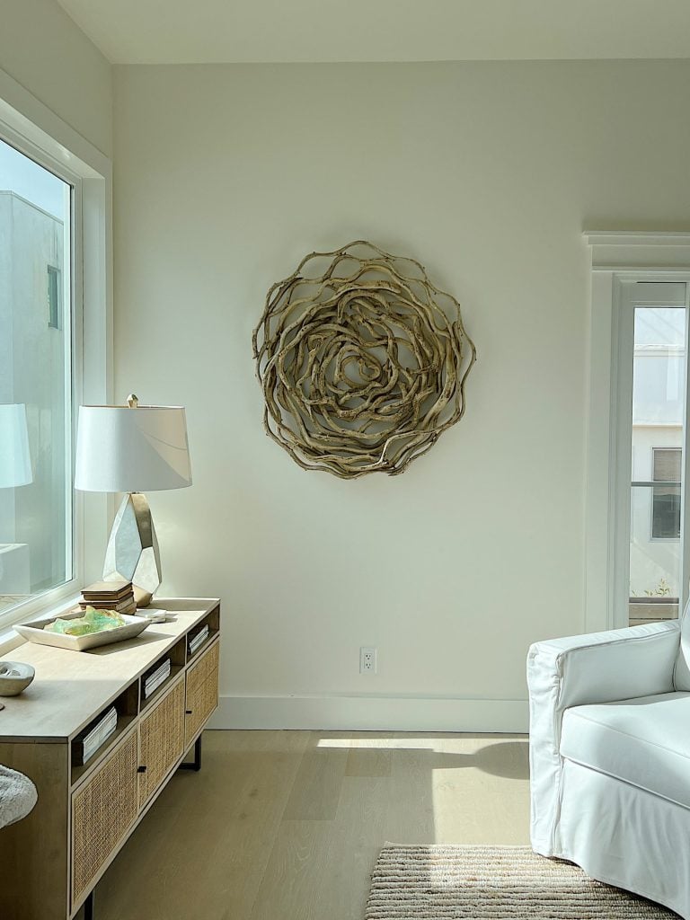 Large round artwork made from vines hanging on the wall.