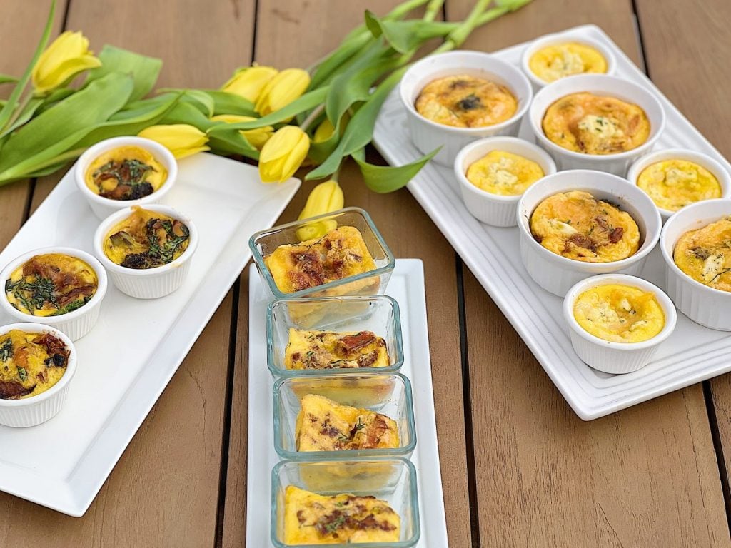 A Mother's Day Brunch buffet with four different kinds of egg bites and some pretty yellow tulips.