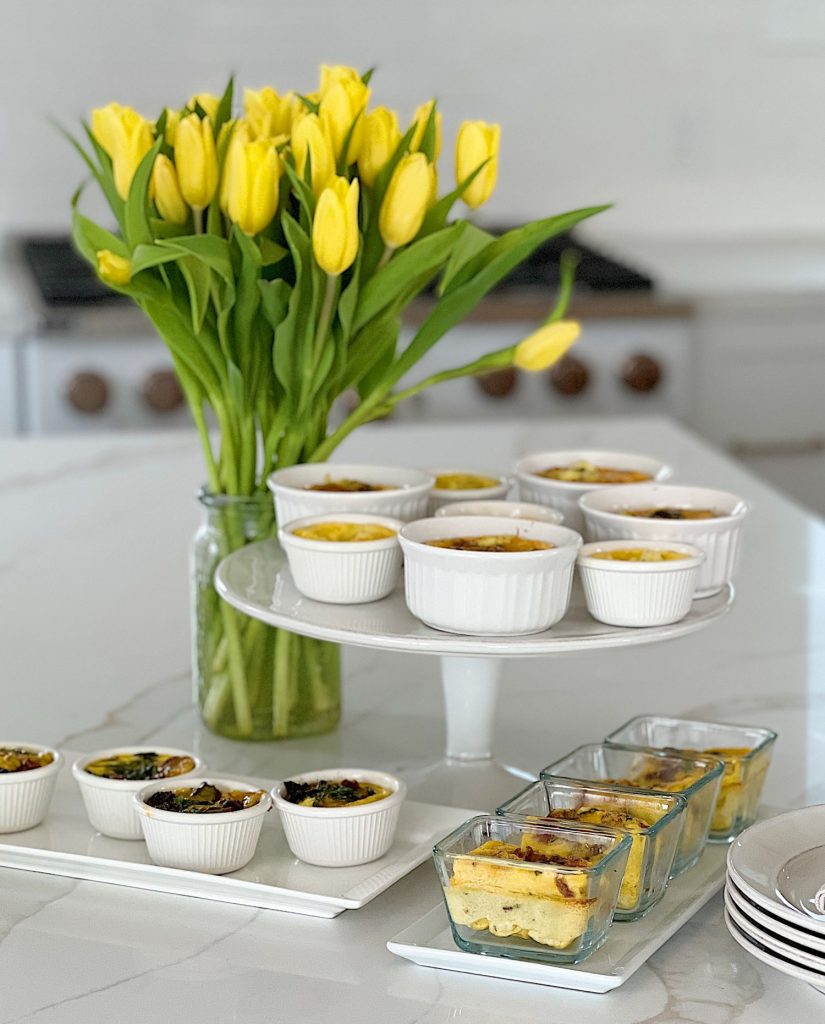 A Mother's Day Brunch buffet with four different kinds of egg bites and some pretty yellow tulips.