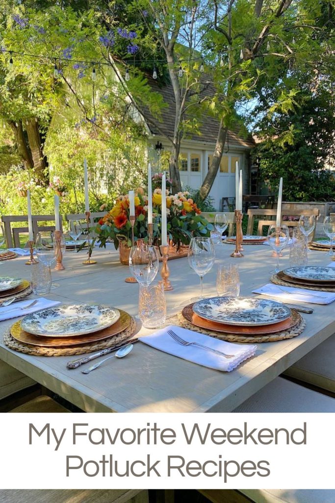 Potluck dinner in the backyard with a wood table, place settings with copper chargers and floral plates and copper accents.