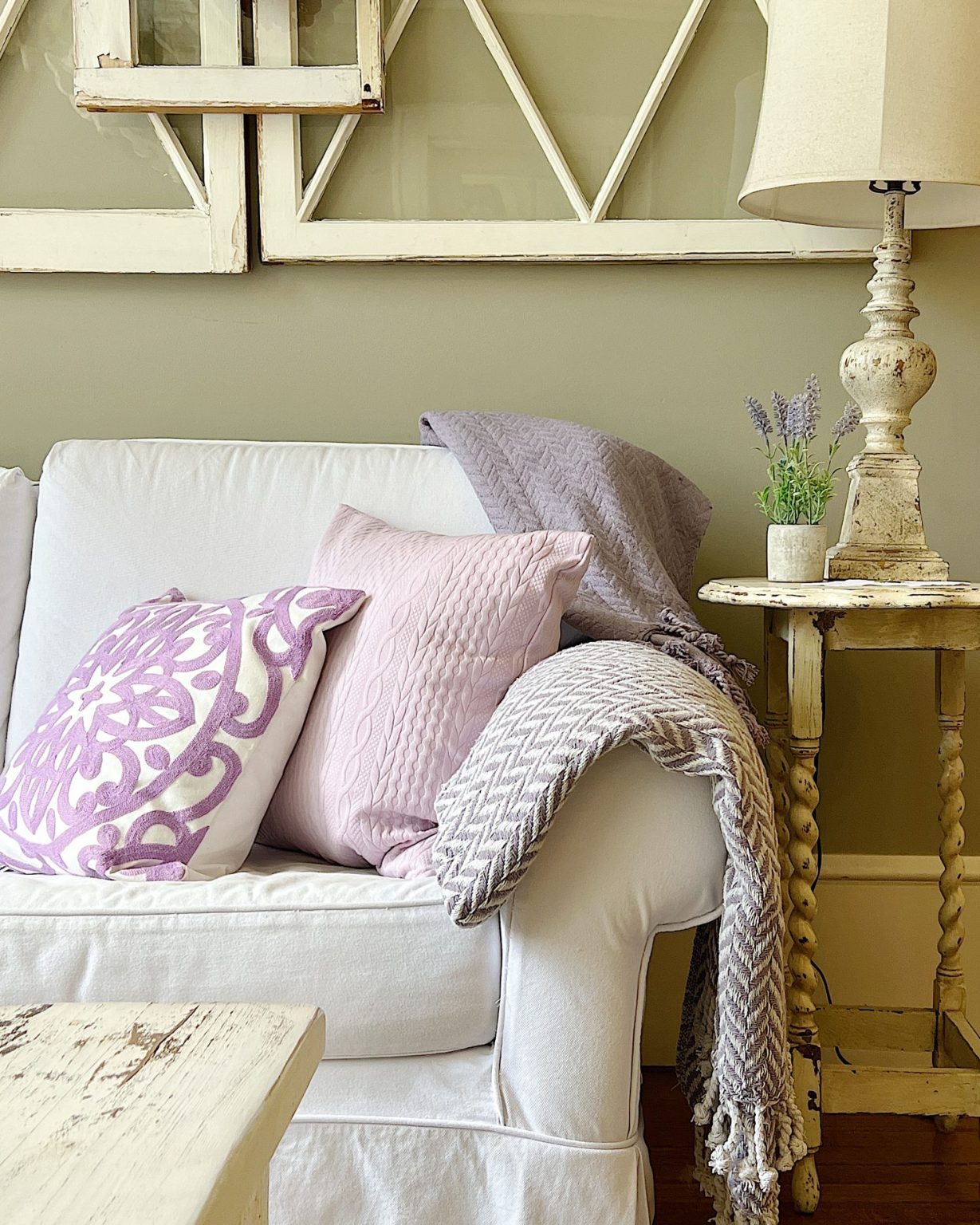Purple throw pillows on a white couch.