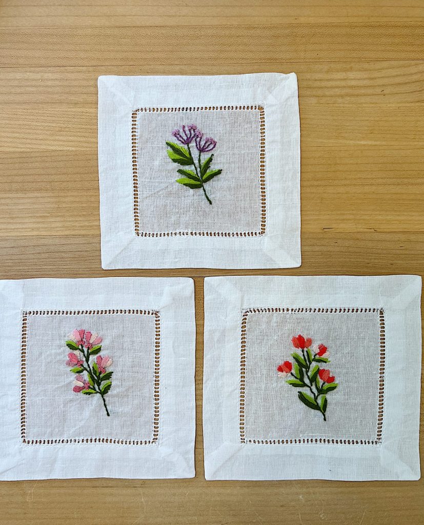 Three cotton/linen napkins embroidered with flowers