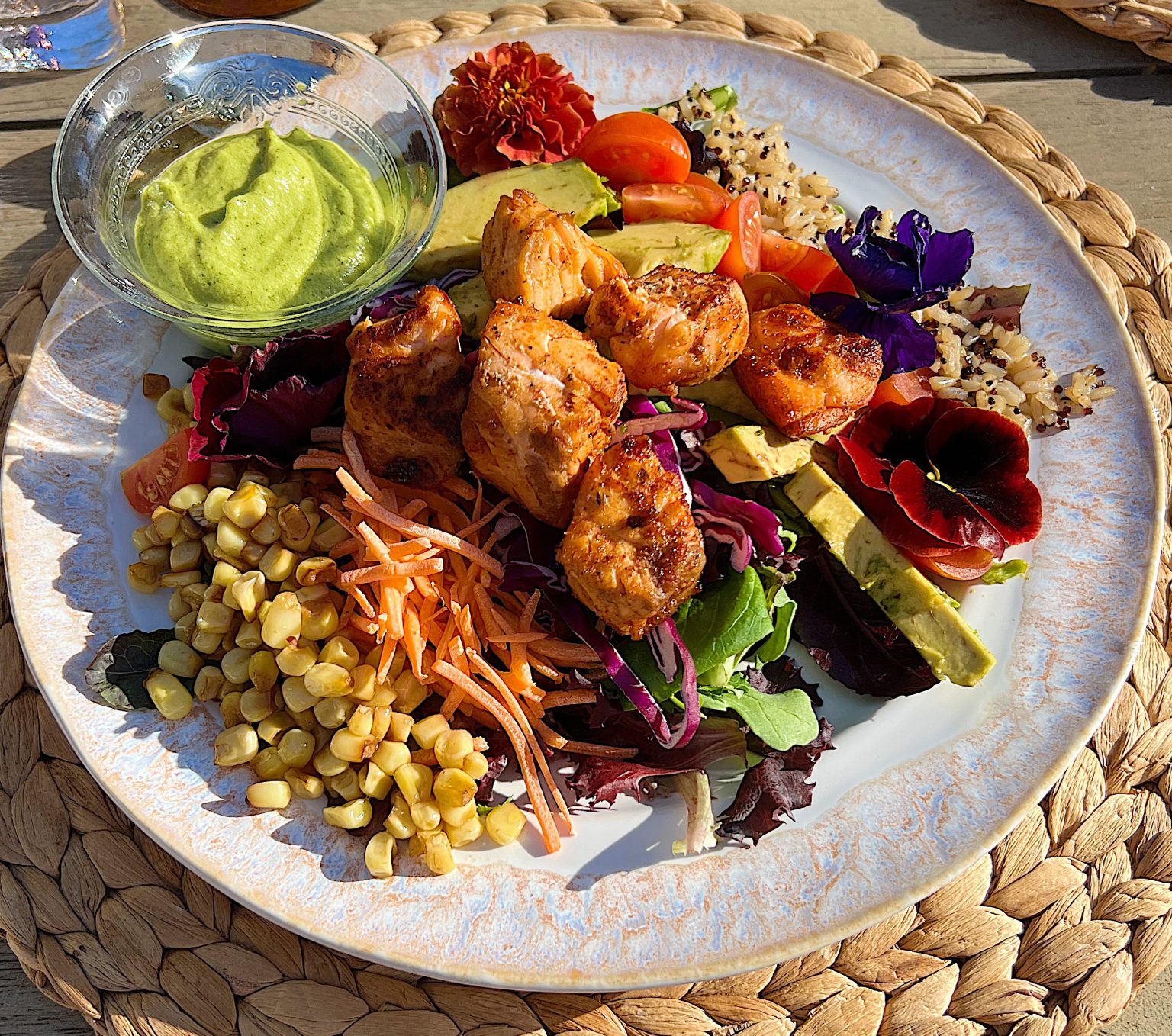 Spring Salad Recipe with Spice-Rubbed Salmon, mixed greens, tomatoes, avocados, cabbage, carrots, corn, and cilantro dressing.