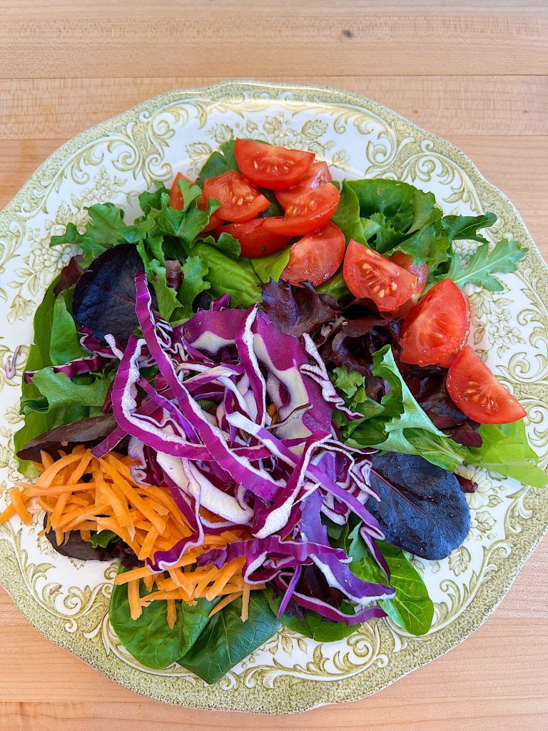 Spring Salad Recipe with Spice-Rubbed Salmon, mixed greens, tomatoes, avocados, cabbage, carrots, corn, and cilantro dressing.