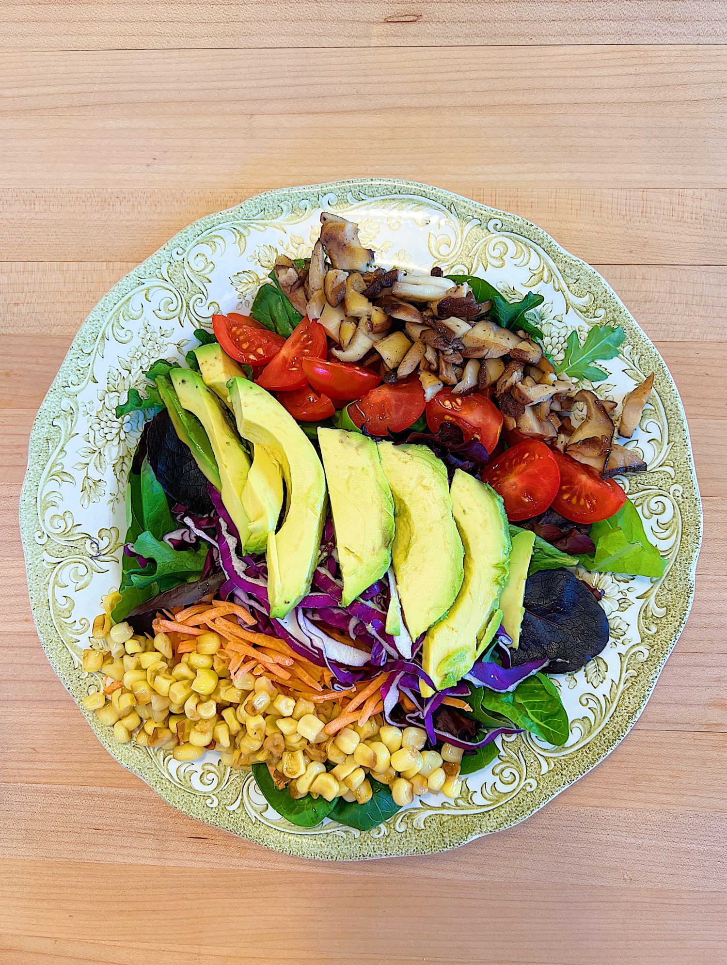 Spring Salad Recipe with Spice-Rubbed Salmon, mixed greens, tomatoes, avocados, cabbage, carrots, corn, and cilantro dressing.