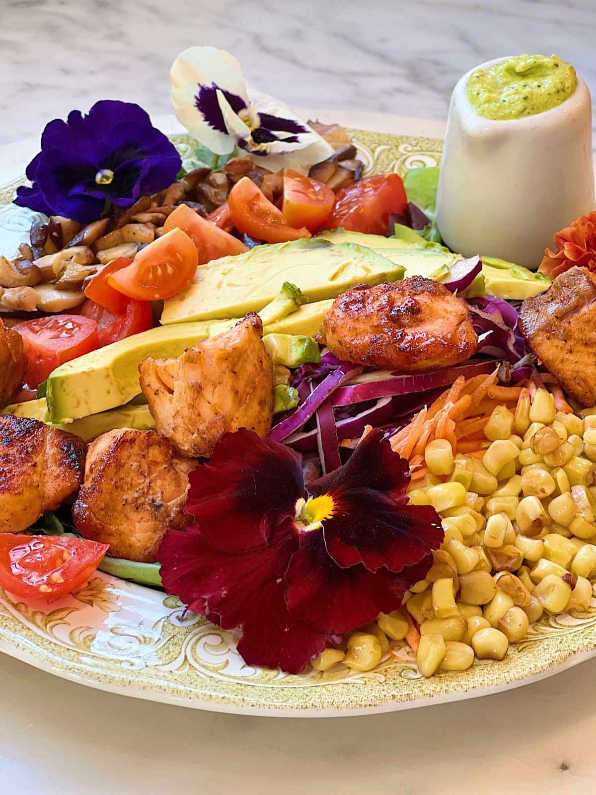 Spring Salad Recipe with Spice-Rubbed Salmon, mixed greens, tomatoes, avocados, cabbage, carrots, corn, and cilantro dressing.