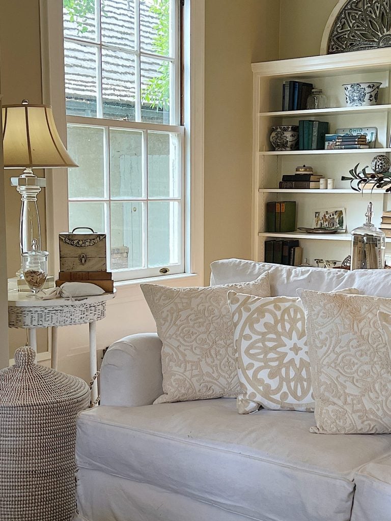 White and tan throw pillows on a white couch.