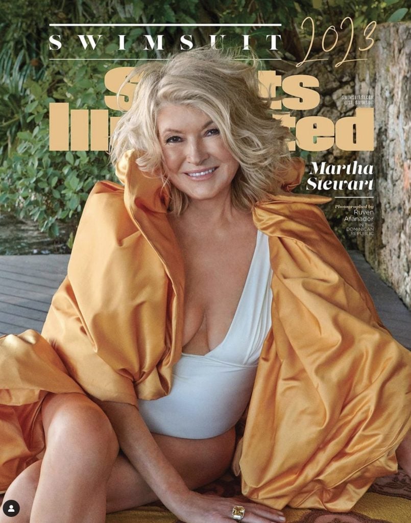 Martha Stewart Sports Illustrated Swimsuit Cover photo. Martha is wearing a plunging white one-piece bathing suit with a silk taffeta puffy wrap in an apricot color. 