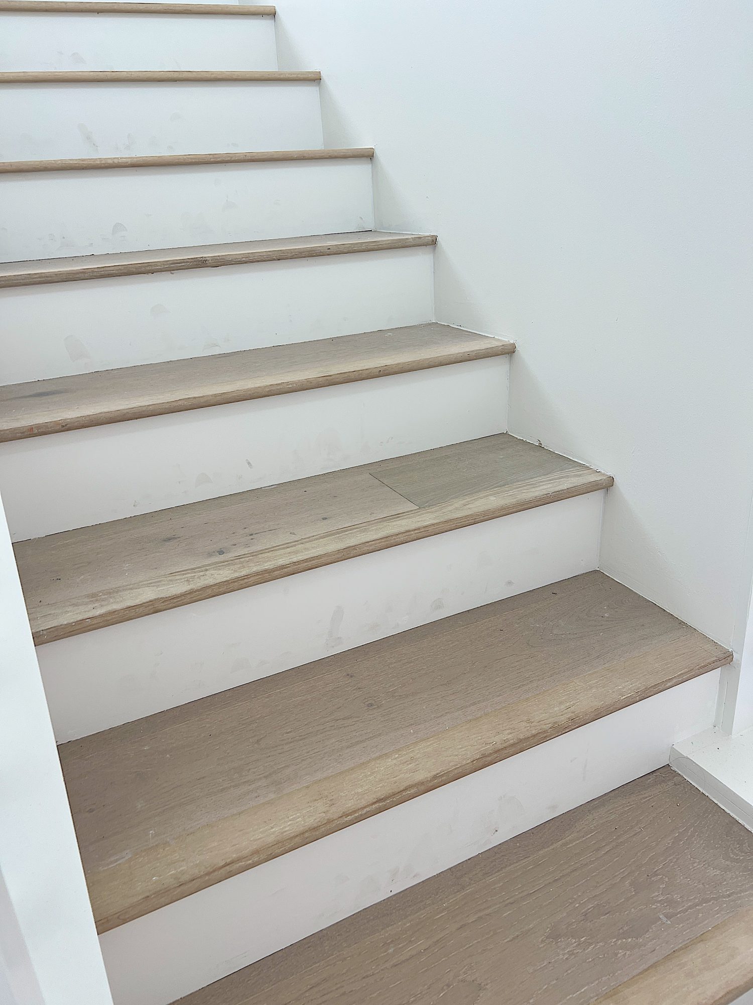 A flooring remodel used the existing hardwood floors and new engineered hardwood.