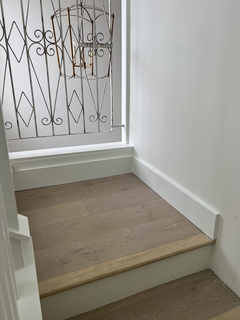 A flooring remodel used the existing hardwood floors and new engineered hardwood.