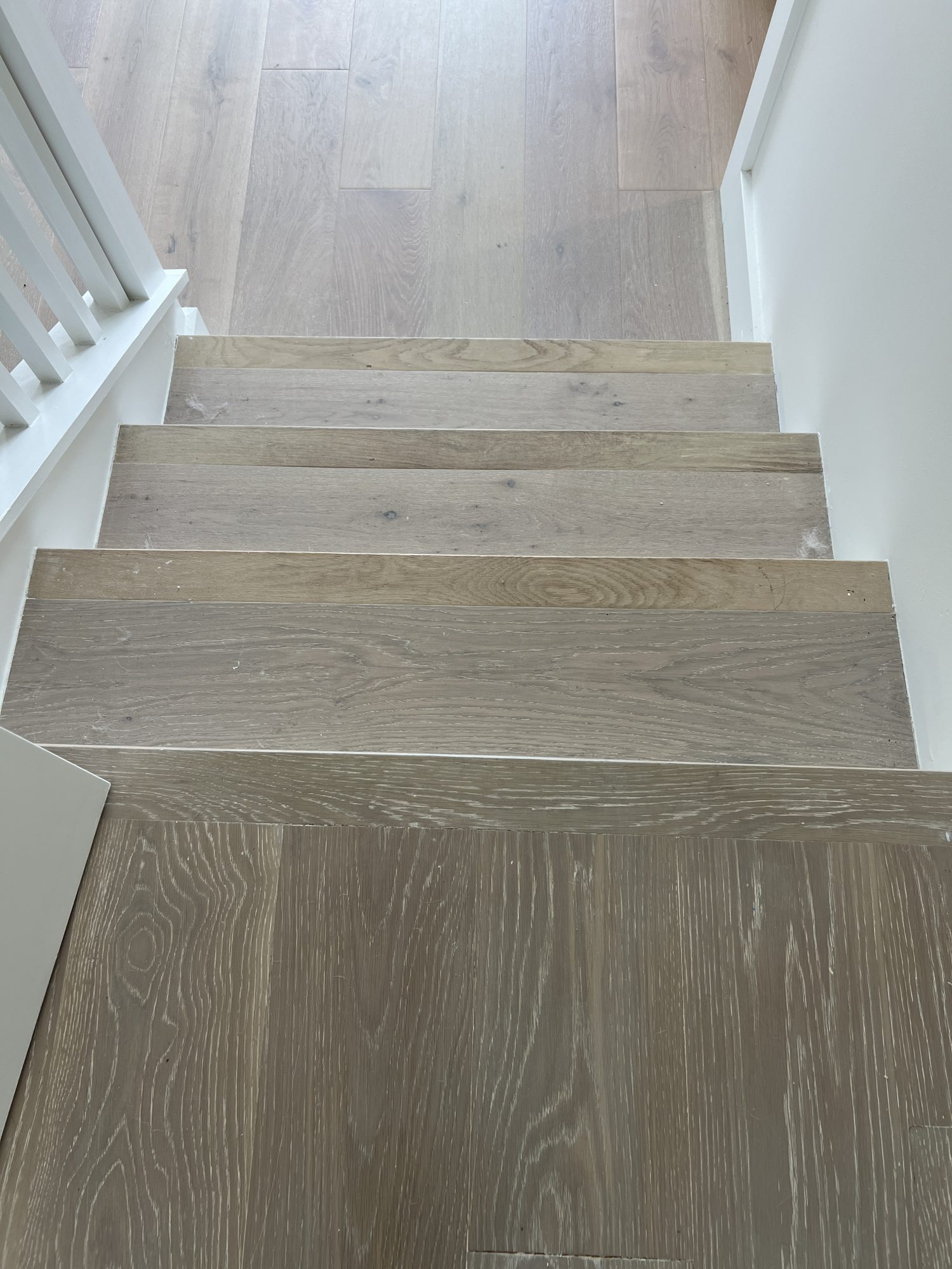 A flooring remodel used the existing hardwood floors and new engineered hardwood.