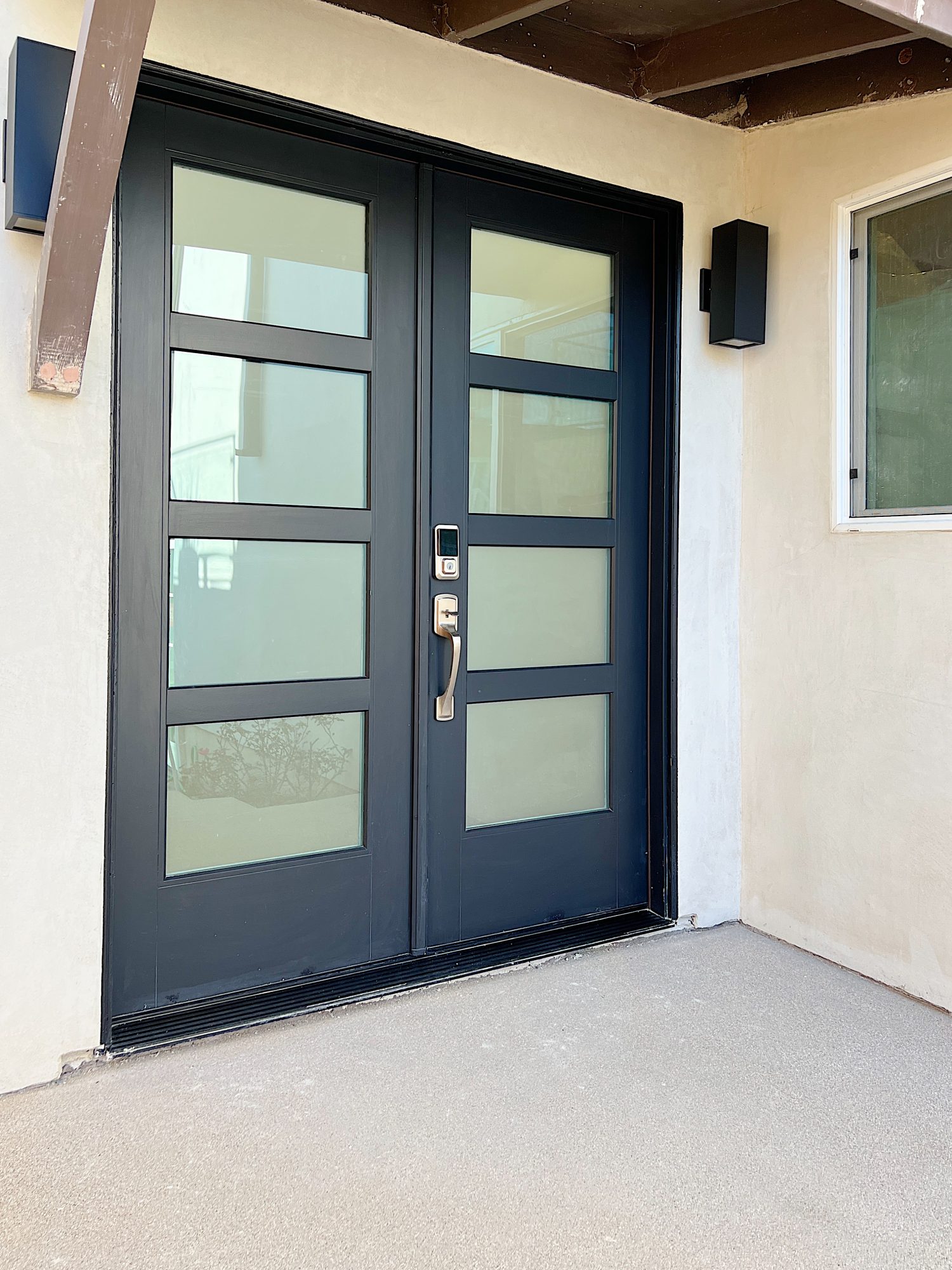 The modern black front door made from fiberglass at the beach house.