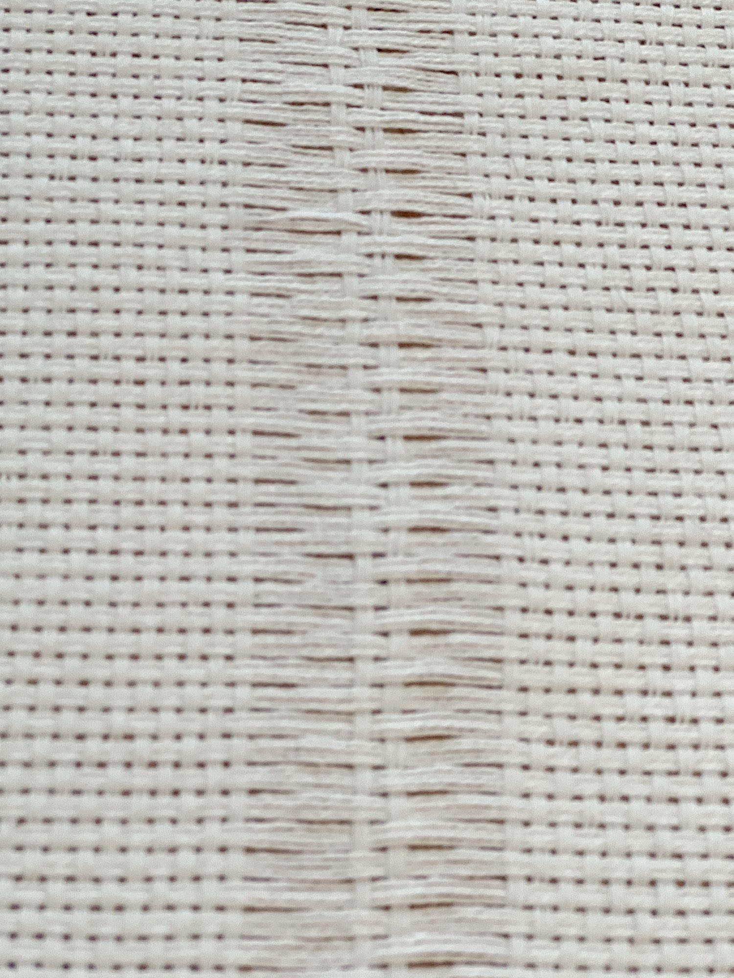 Handmade monk cloth pillow with yarn being constructed.