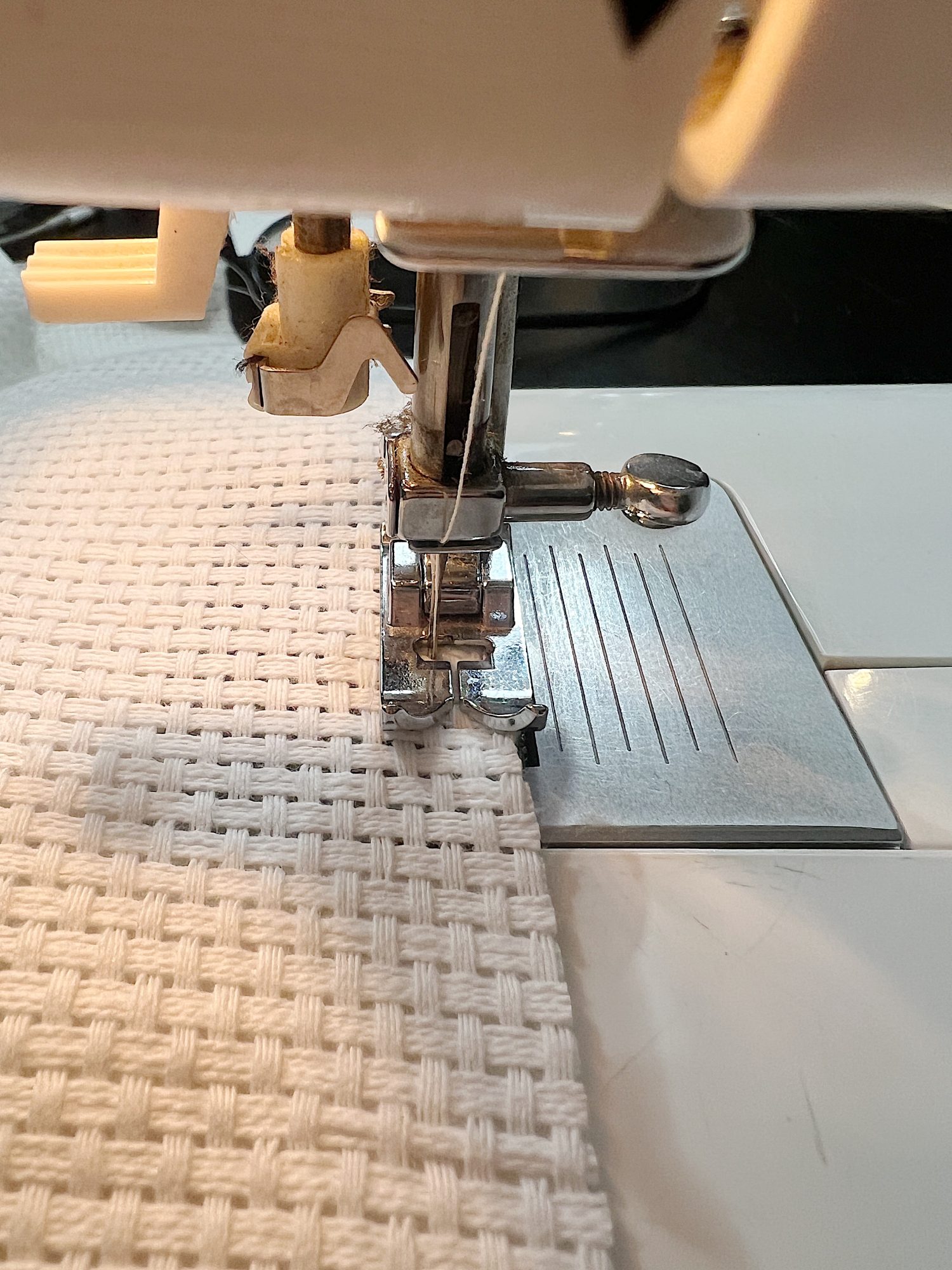 Handmade monk cloth pillow with yarn being constructed.