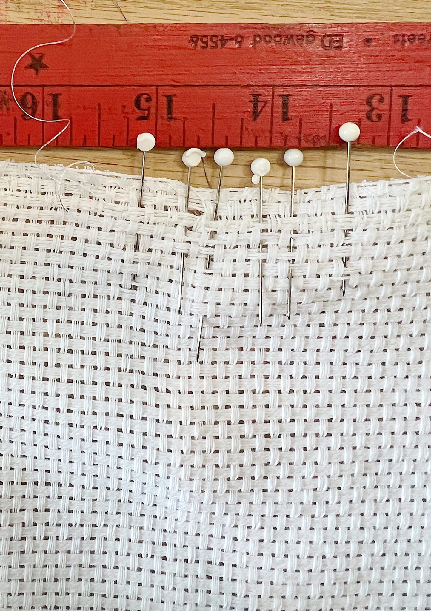 Handmade monk cloth pillow with yarn being constructed.