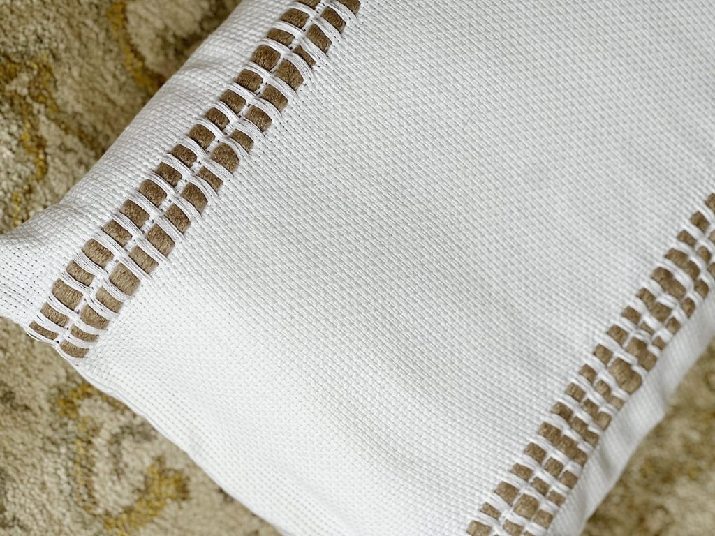 Handmade monk cloth pillow with yarn.
