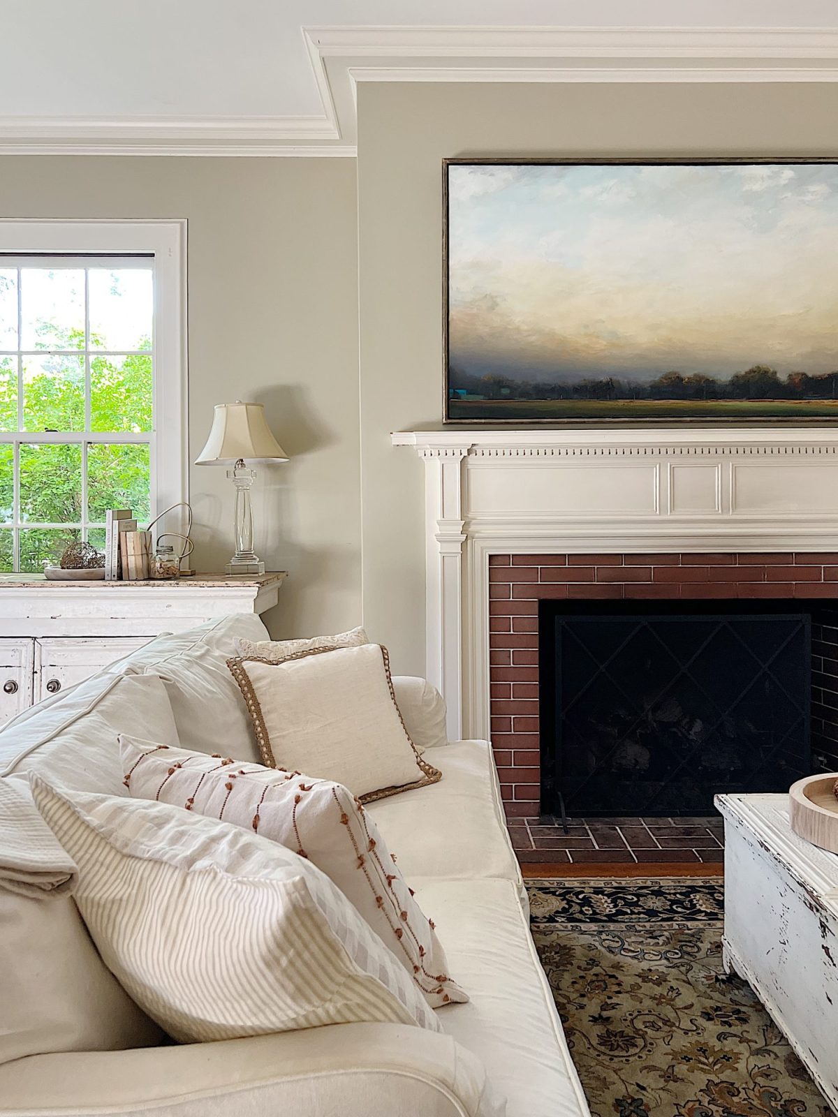 A newly refreshed living room with light couches, furniture, and accents.