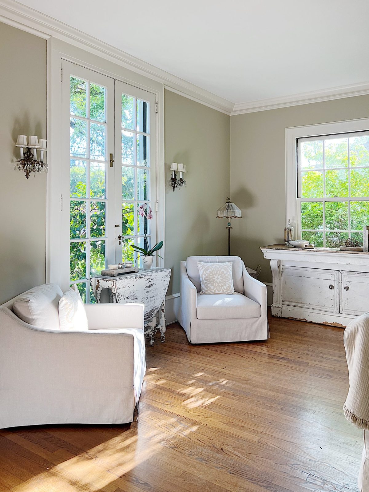 A newly refreshed living room with light couches, furniture, and accents.