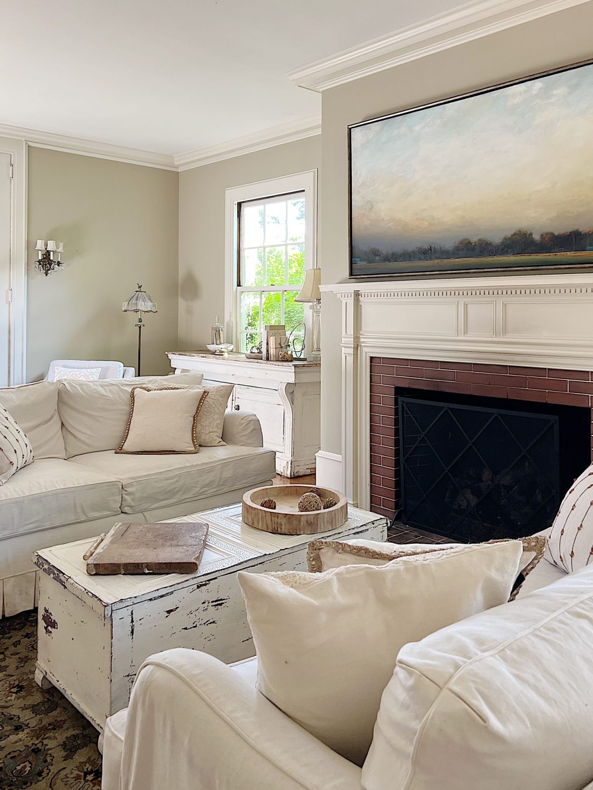 A newly refreshed living room with light couches, furniture, and accents.
