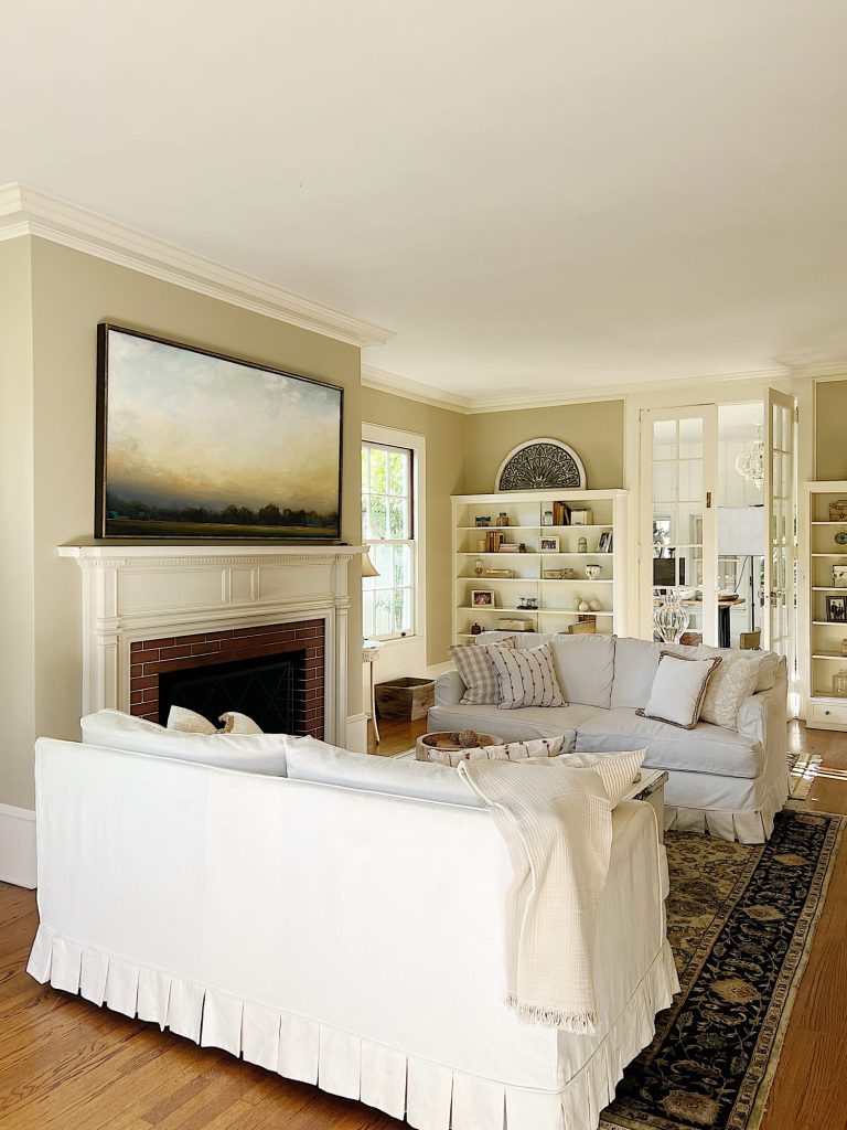 A newly refreshed living room with light couches, furniture, and accents.