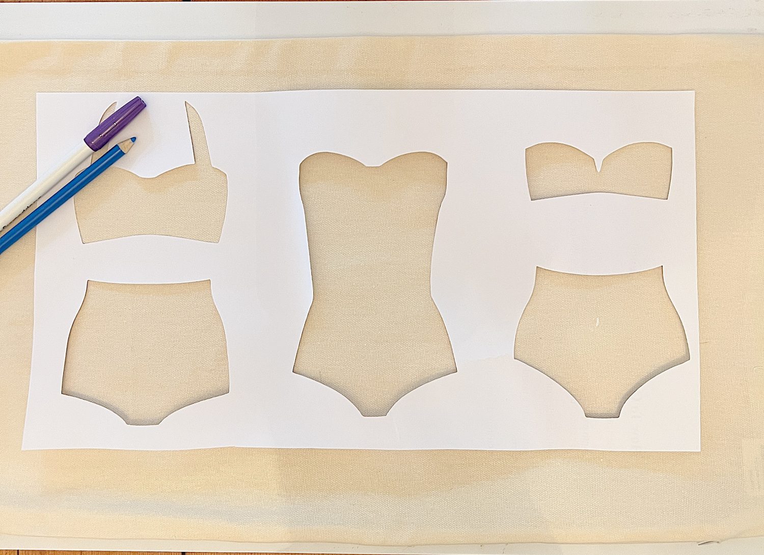 DIY pillow featuring painted and stitched vintage bathing suites in a modern coastal vintage style.