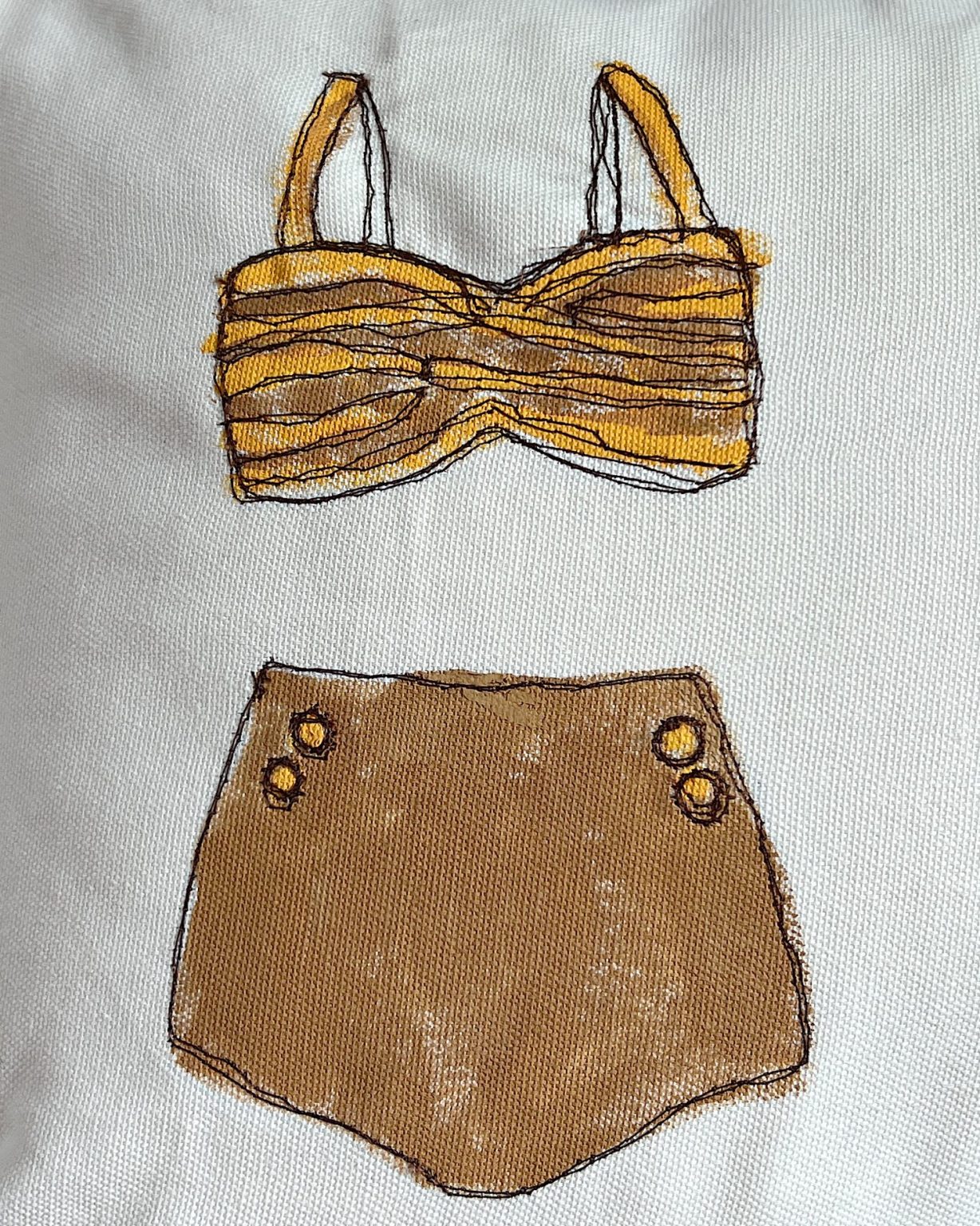 DIY pillow featuring painted and stitched vintage bathing suites in a modern coastal vintage style.