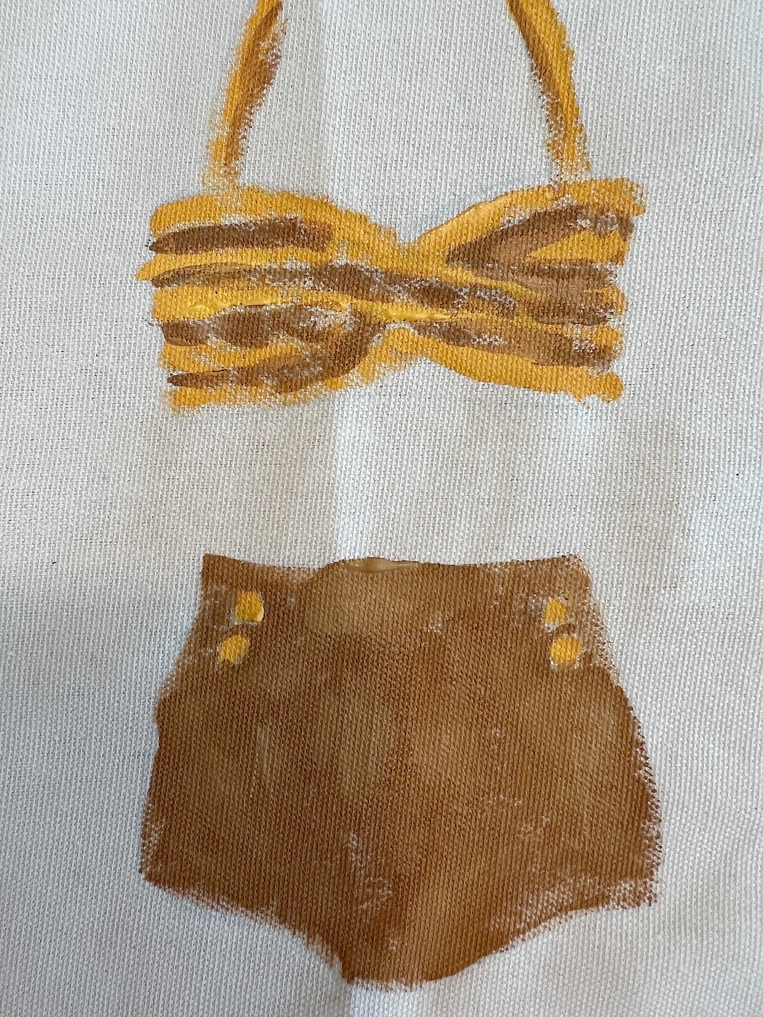 DIY pillow featuring painted and stitched vintage bathing suites in a modern coastal vintage style.