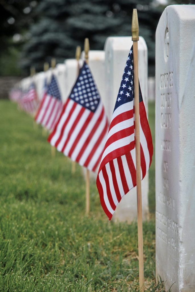 Memorial Day tribute with tombstones and flags